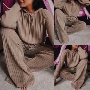 Detailed view of women's loose knit loungewear set with hooded top and wide-leg pants