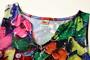 Macro view of V-neckline detail on vintage floral print sleeveless dress fabric
