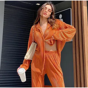 Stylish orange pleated long-sleeve shirt and matching wide-leg pants two-piece casual set