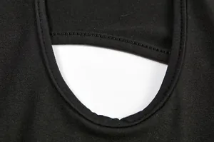 Close-up view of the delicate cutout design and stitching on a black bodycon dress