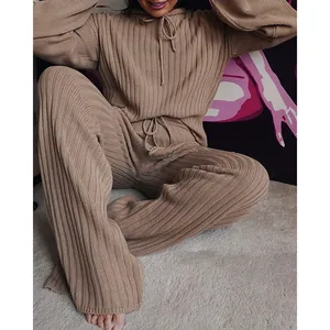Detailed macro shot of women's beige ribbed knit hoodie and wide-leg lounge set texture