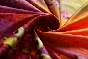 Detailed macro view of vintage floral print fabric showing silky texture and vibrant colors