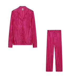 Fuchsia pleated two-piece set featuring a long-sleeve shirt and matching trousers.
