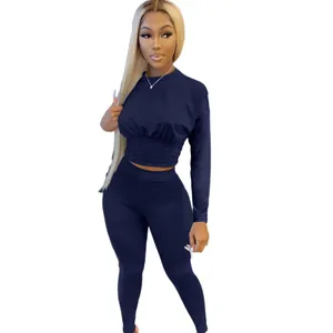 Women's two-piece navy blue lounge set with long-sleeve crop top and high-waisted leggings.