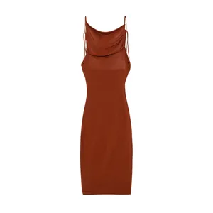 Detail of a rust red bodycon dress with a cowl neck and thin spaghetti straps.