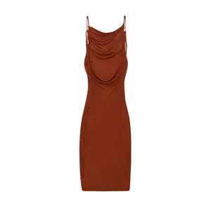 Detail view of a rust red cowl neck dress with thin straps on a white background