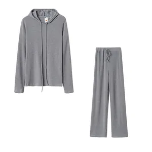 Close-up view of women's gray ribbed two-piece lounge set with hooded top and pants