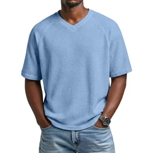 Detail view of light blue waffle knit fabric and raglan sleeve design on men's V-neck T-shirt