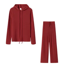 Two-piece burgundy ribbed loungewear set with long sleeve hoodie and wide leg pants
