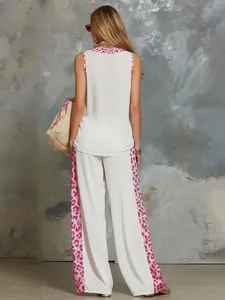 Back view of a white two-piece set featuring vibrant pink leopard print trim detail