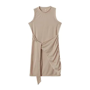 Sleeveless crewneck ruched irregular dress with tie-waist detail in apricot.