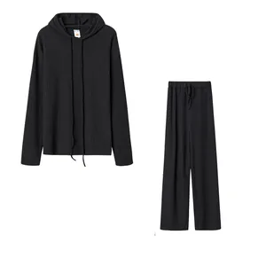 Two-piece black ribbed loungewear set with hooded sweatshirt and wide-leg pants.