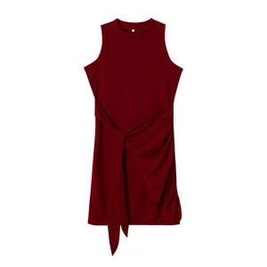 Close-up of sleeveless burgundy dress featuring pleated side and tie-waist detail.