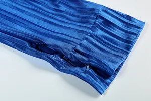Detailed macro view of the pleated cuff construction with thumbhole on royal blue fabric