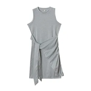 Detailed view of a grey sleeveless dress with pleated waist and irregular hemline.