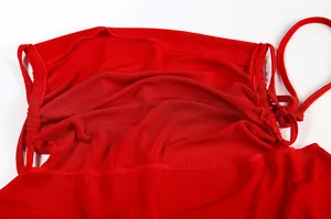 Detailed view of red ruffled bodice and tie straps on a sexy backless halter dress