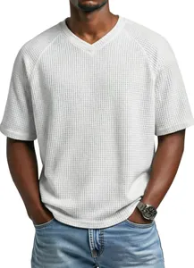 Close-up of men's white waffle knit V-neck T-shirt with raglan sleeves and textured fabric.