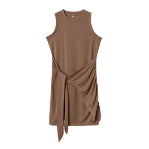 Detailed view of a brown sleeveless crewneck ruched wrap dress with an asymmetrical hem