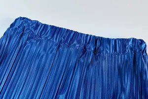 Detailed macro view of the elastic waistband and pleated texture in vibrant royal blue.