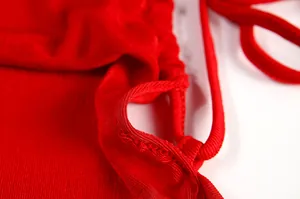 Close-up detail of high-quality stitching and red ribbed fabric on a halter dress