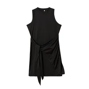 Close-up detail of black sleeveless dress with ruched tie waist and asymmetric hem
