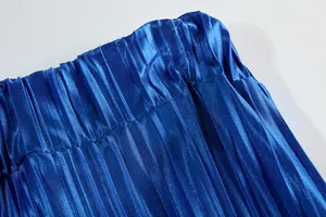 Detail shot showing the fine pleated texture and elastic waistband of the blue satin garment