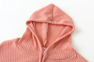 Detailed macro view of soft pink ribbed fabric on a women's casual hooded sweatshirt