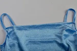 Nahaufnahme des weichen Samtstoffs und des eckigen Ausschnitts eines blauen Trägerkleids