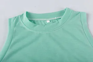 Close-up view of the mint green round neckline and size label on a sleeveless dress
