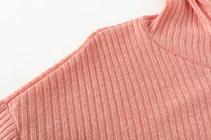 Close-up of pink ribbed knit fabric and shoulder seam on a women's casual hooded sweater