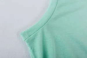 Close-up of mint green soft fabric showing high-quality stitching on sleeveless dress