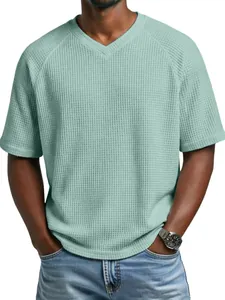 Detailed view of men's waffle knit V-neck T-shirt in mint green with raglan sleeves.