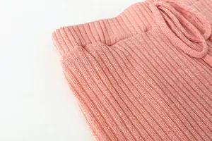 Close-up of the pink ribbed knit fabric texture and elastic drawstring waistband