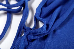 Close-up macro detail of the high-quality fabric texture and blue straps of a dress