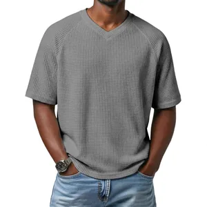 Professional shot of a men's grey waffle knit V-neck T-shirt with stylish raglan sleeves