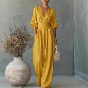 Elegant yellow V-neck jumpsuit with cinched waist and wide legs for summer fashion