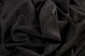 Macro view of black knit fabric texture for a thickened summer backless maxi dress.