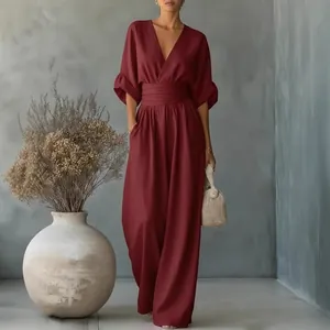 Elegant burgundy V-neck high-waisted jumpsuit with wide-leg trousers and puff sleeves