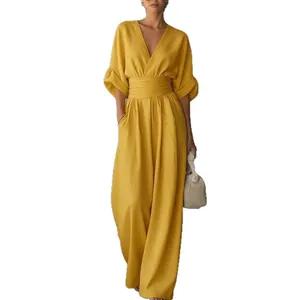 Elegant yellow V-neck jumpsuit featuring a cinched waist and flowing wide leg silhouette