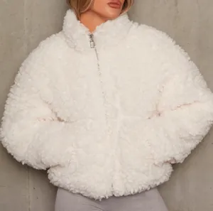 Close-up of a cozy white sherpa fleece jacket for women with high collar and zipper.
