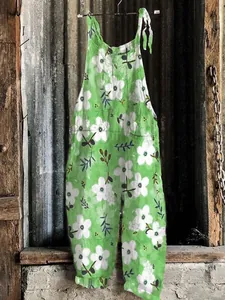 Vintage green jumpsuit featuring white floral print and comfortable wide leg design