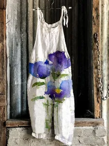 Detailed view of white wide-leg jumpsuit with artistic purple floral watercolor print