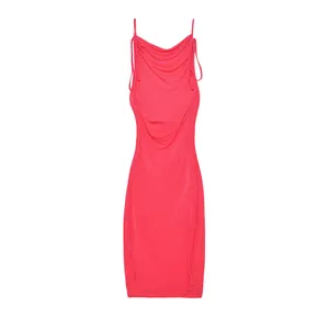 Close-up detail of a vibrant hot pink ruched bodycon dress with side drawstrings.