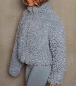 Side view detail of a light blue cropped sherpa jacket showing the fuzzy fleece texture