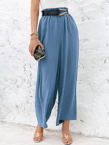 Close-up of solid color high waist wide leg pants with textured linen fabric and belt.