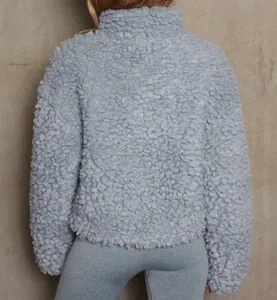 Detailed back view of a light blue cropped faux shearling sherpa jacket for women