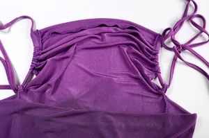Detailed view of purple halter neck dress showing ruched fabric and thin lace-up ties