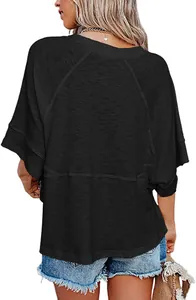 Back view of a premium black loose-fitting t-shirt with flare sleeves and crew neck.