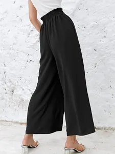 Back view of elegant black high-waisted wide-leg trousers with ruffled elastic waist