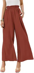 Close-up of rust high waist wide-leg trousers with an elastic smocked waistband